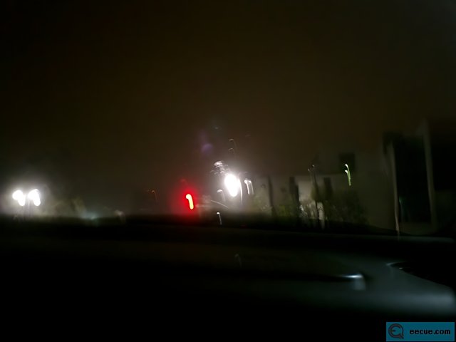 Blurry Traffic Light in the Night Sky