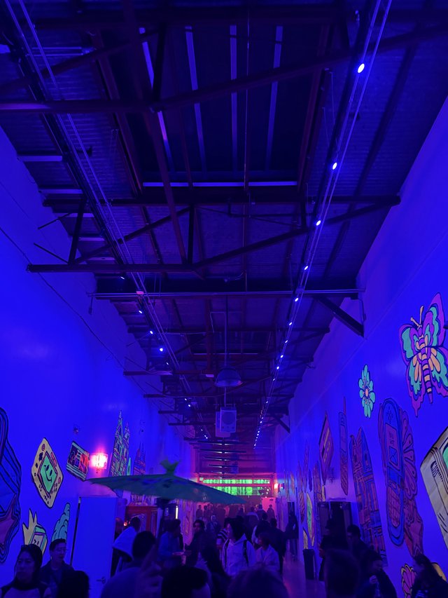 Immersive Blue-Lit Electronic Music Venue with Crowd