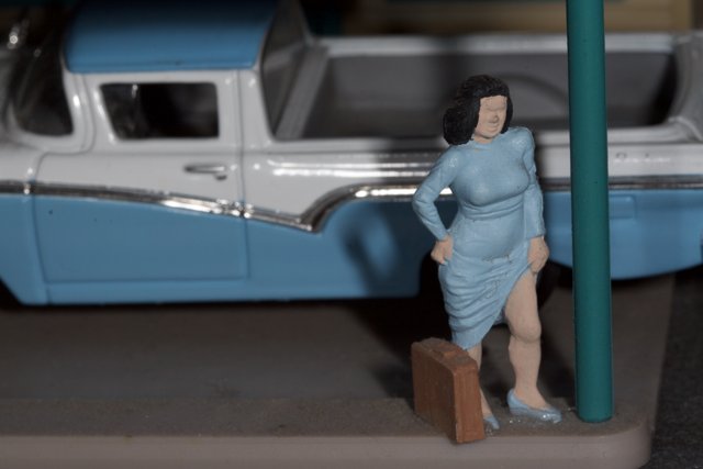 Woman Figurine and Blue Truck