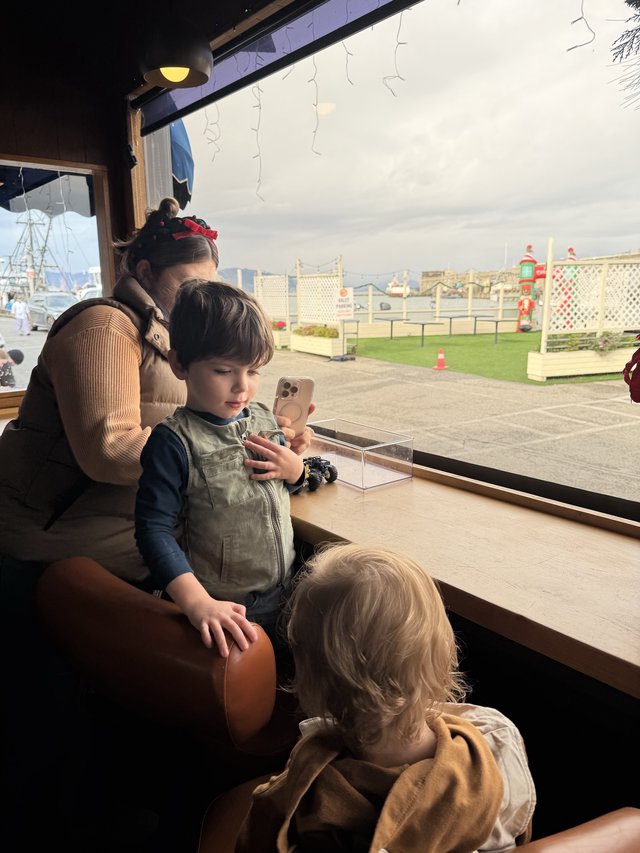 Family Moment by the Window at Winter Attraction