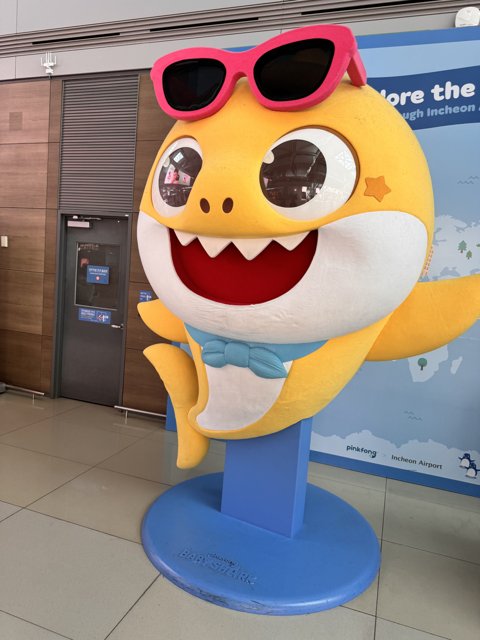 Sunglass-Donned Shark Mascot at Incheon Airport