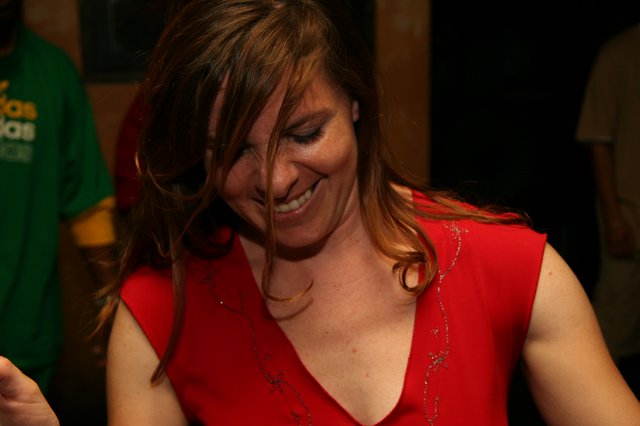 Joyful Woman in Red Laughing at Party