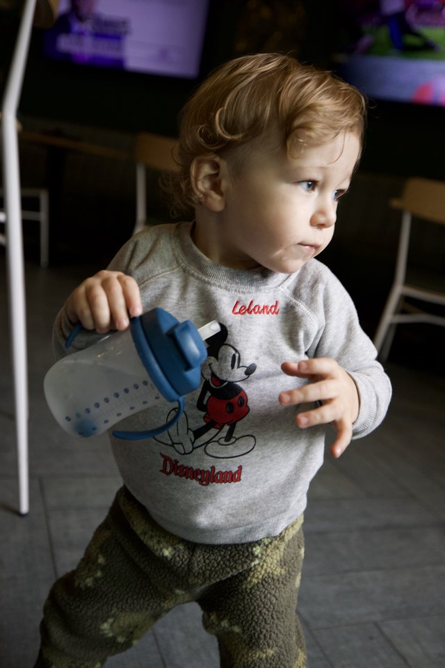 Toddler with Baby Bottle in Disneyland Sweatshirt