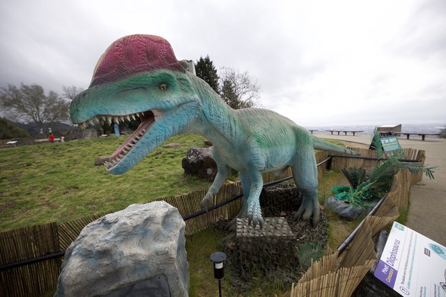 Turquoise Spinosaurus Dinosaur Statue at Outdoor Park