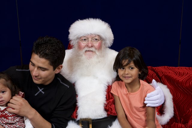 Santa Claus brings smiles to a family on the couch