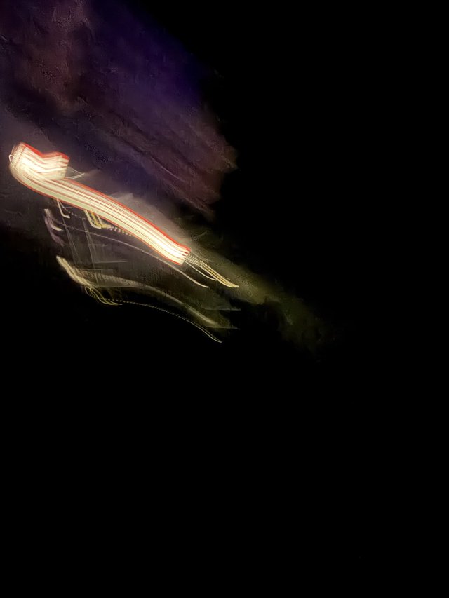 Light Trails Through Purple Night Sky