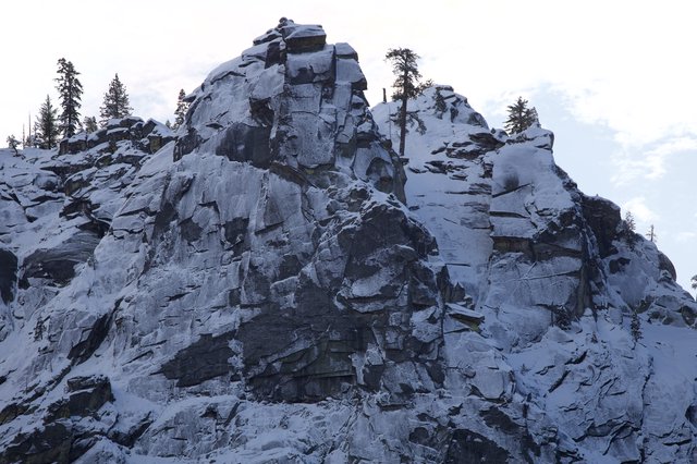 Snow-Covered Rocky Peak in Winter Mountain Landscape