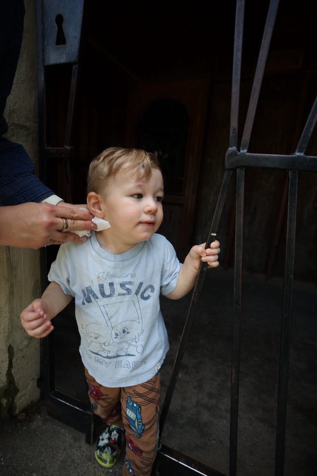 Young Child Getting Ear Cleaned by Parent
