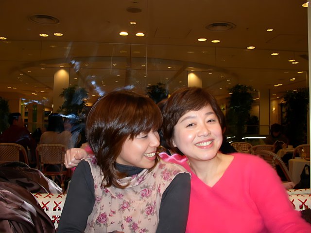 Two Asian Women Enjoying a Meal at a Restaurant