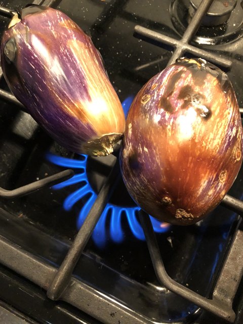 Purple Eggplants Sizzling on the Stove