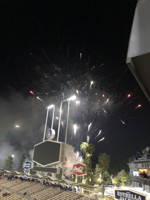 Fireworks illuminate the night sky over baseball stadium