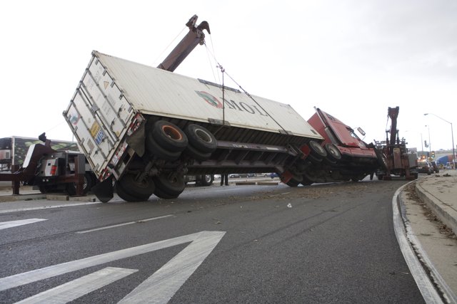 Crane Lifts Overturned Truck