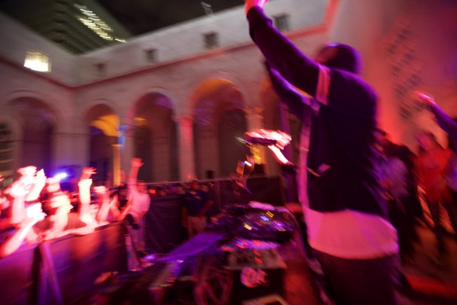DJ spinning at a crowded urban nightclub