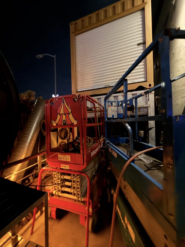 Red Scissor Lift at Night Industrial Loading Dock