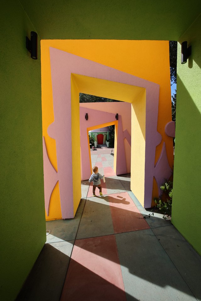 Child Walking Through Colorful Architectural Tunnels at Fantasyland