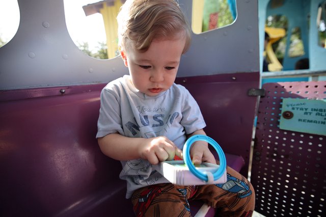 Toddler Playing with Toy at Colorful Playground