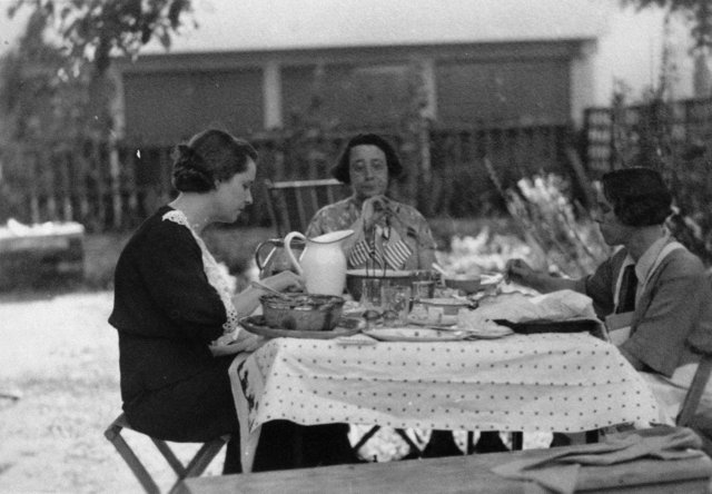 Three Women Enjoying a Meal Outside