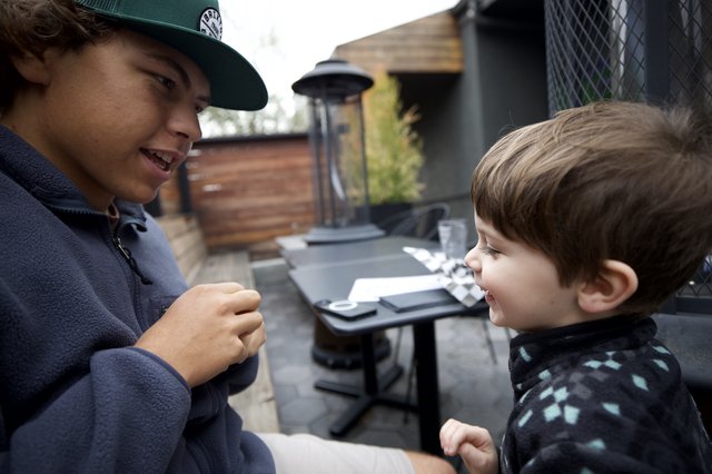 Brothers Sharing a Moment on an Outdoor Patio