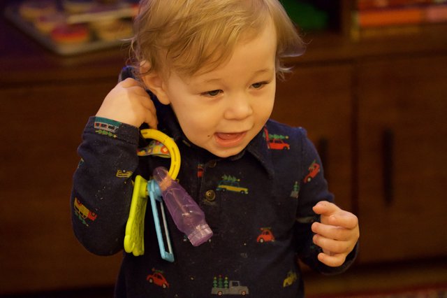 Toddler Playing with Toy Keys at Christmas