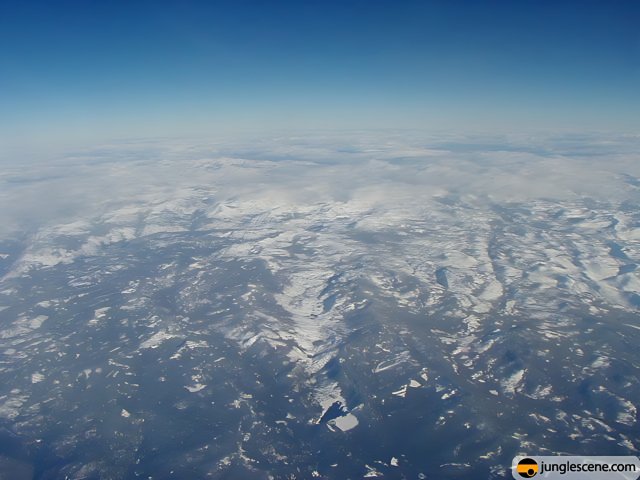 Majestic Snowy Mountains From An Airplane Window