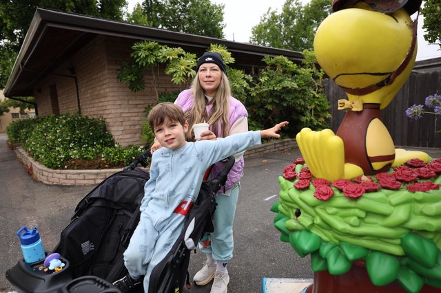 Mother and Child Pose with Woodstock Cartoon Statue