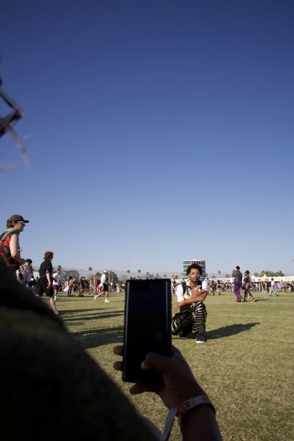 Connected Yet Alone: A Candid Moment at Coachella 2024
