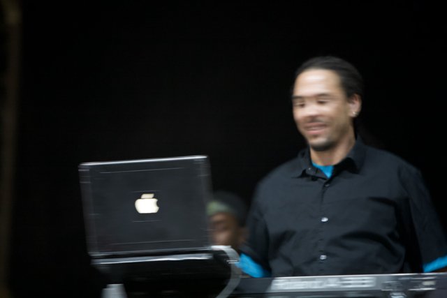 Roni Size Smiling with Laptop