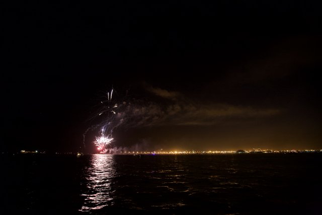 Spectacular Fireworks Display Over the Lake at Night