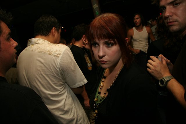Red-Haired Woman in a Club Crowd
