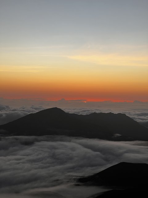 Above the Clouds: A Majestic Sunrise at Mauna Kea