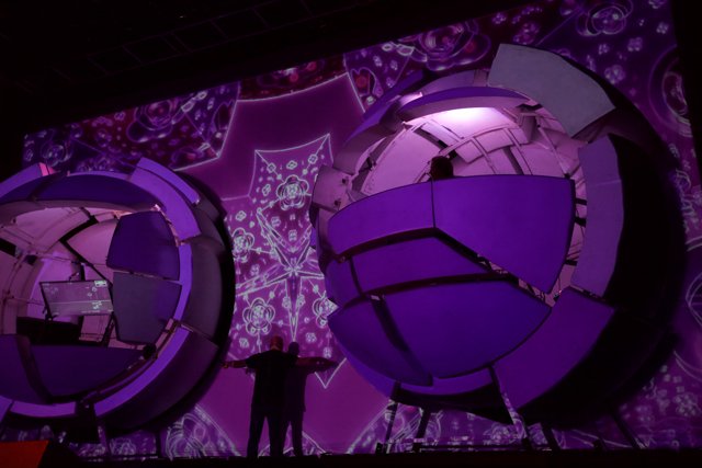 Purple Spheres Illuminating the Stage with a Man in Focus