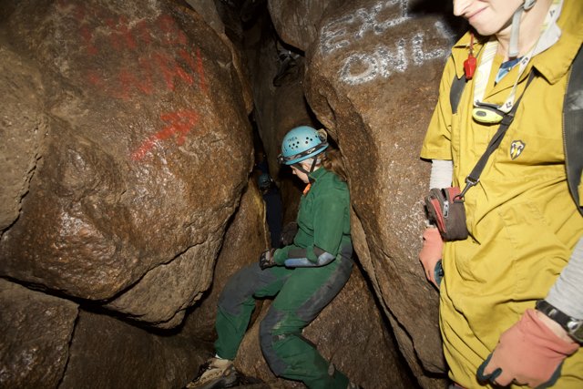 The Adventurous Man in the Green Suit Explores a Cave