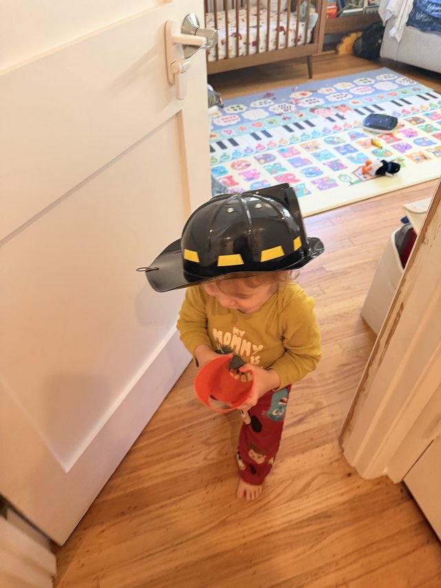 Little Firefighter Ready for Trick-or-Treating at Home