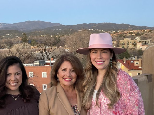 Three Women in Hats Take in the Mountain View
