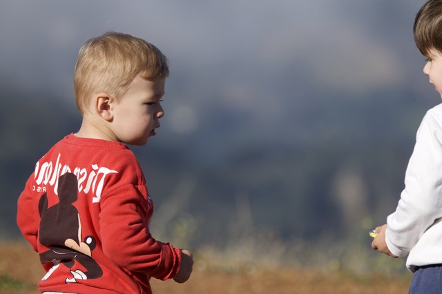 Two Young Boys Share a Tense Outdoor Moment