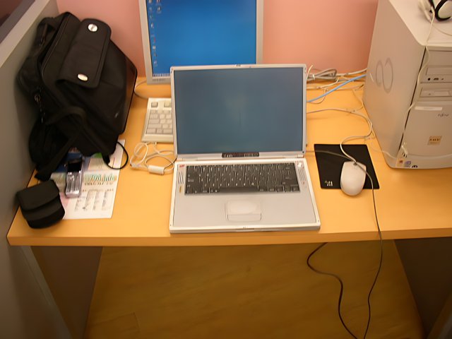 Two Laptops on a Wooden Desk