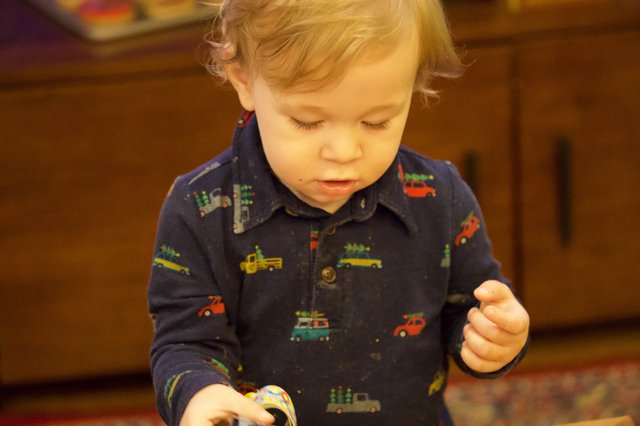 Toddler Focused on Christmas Activity in Vehicle Pajamas