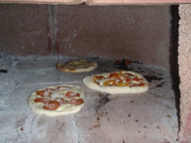 Three Delicious Pizzas in the Oven