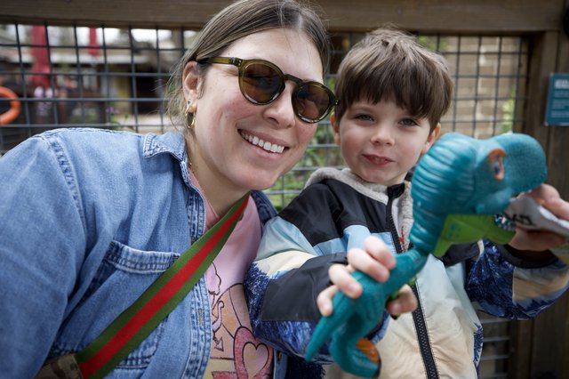Mother and Son with Dinosaur Toy at Zoo