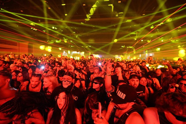 Massive Crowd Electrified Under Laser Light Show