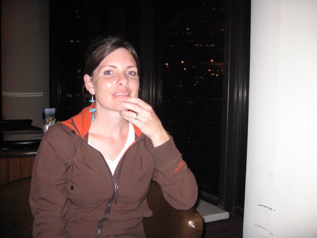 Thoughtful Woman at Night with City Views