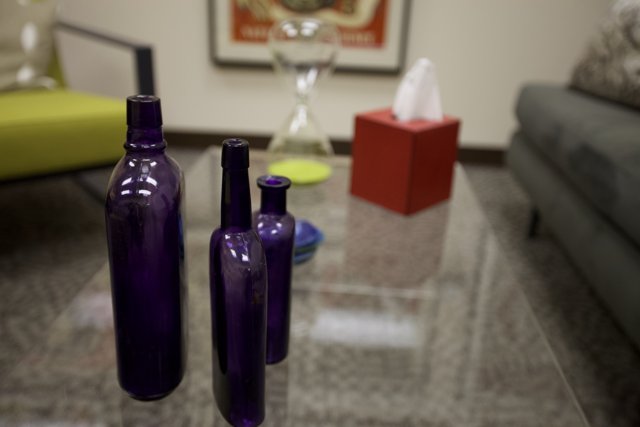 Purple Bottles on Glass Table in Living Room