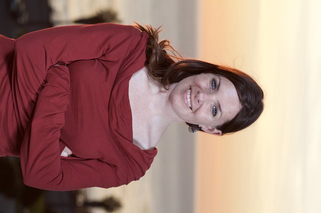 Smiling Woman in Red at Coastal Sunset
