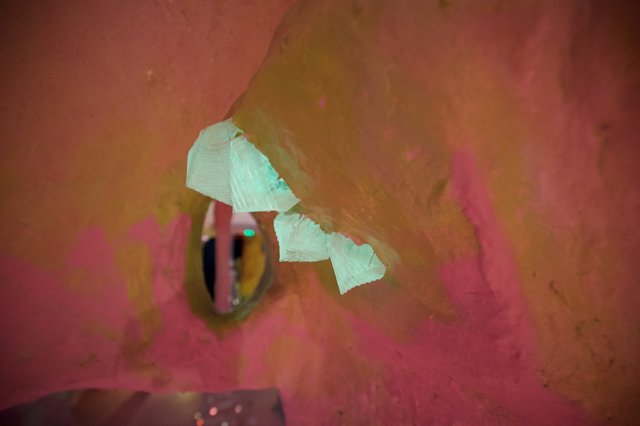 Peeling Paint and Torn Paper in Pink Adobe Wall