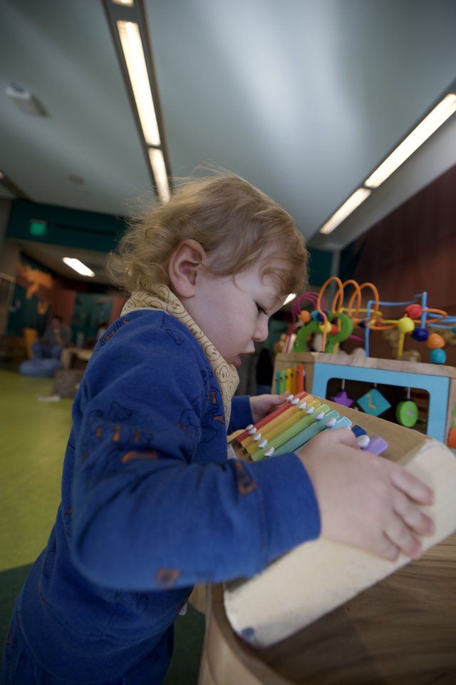 Young Child Exploring Educational Toys in Play Space