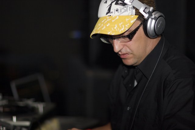 Black-clad man with headgear and headphones