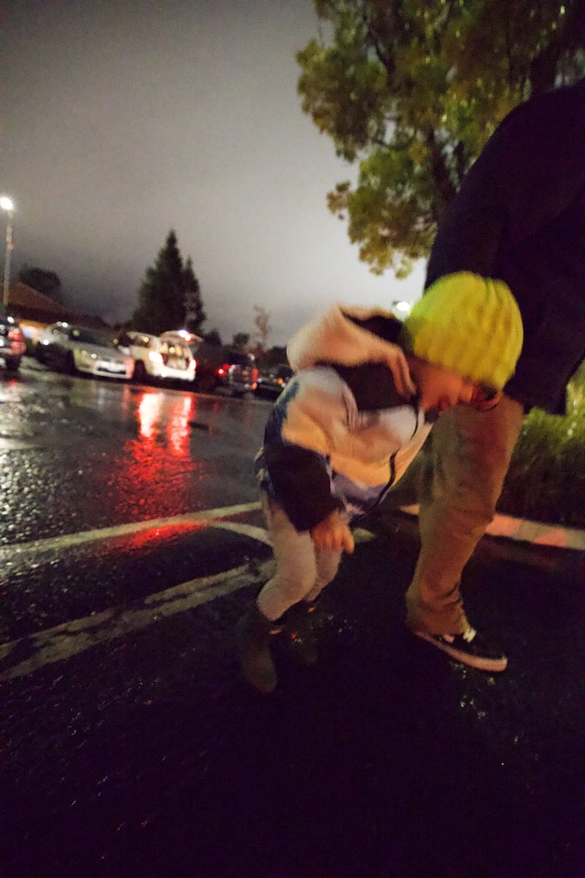 Rescue Worker Assists Person During Rainy Night Emergency