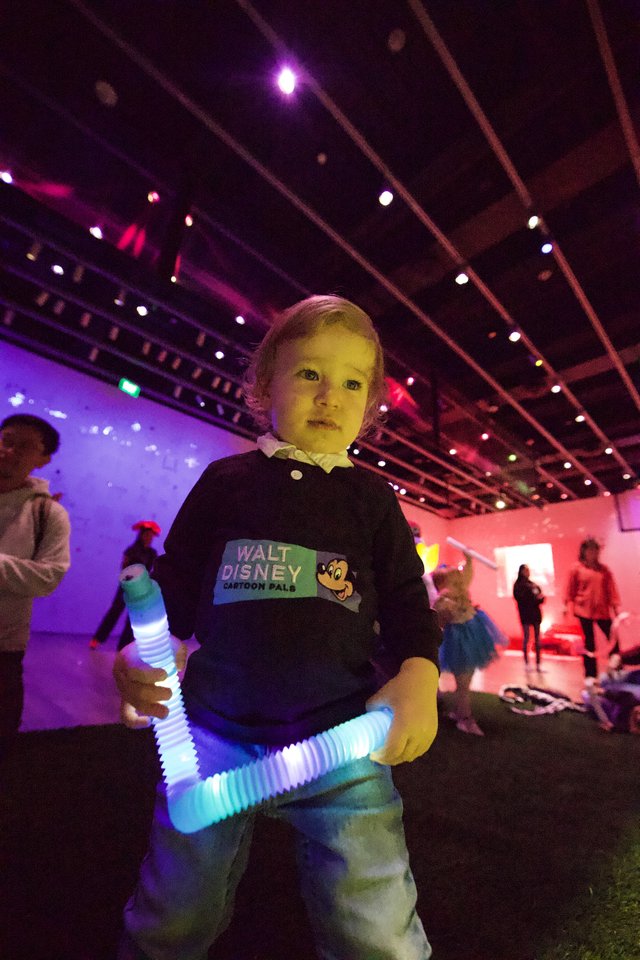Young Child at Baby Rave with Glowing Light Toy