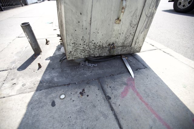Rusty Metal Box on the Sidewalk