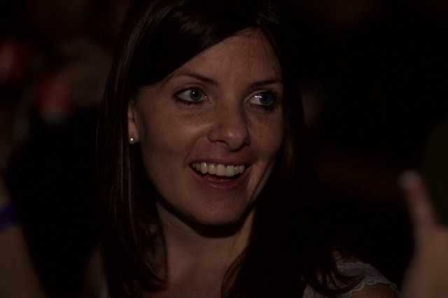 Candid Smile in the Darkness of a Dimly Lit Venue